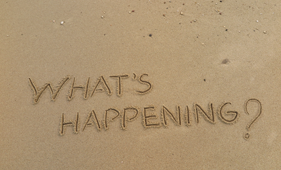 image of words in the sand what's happening